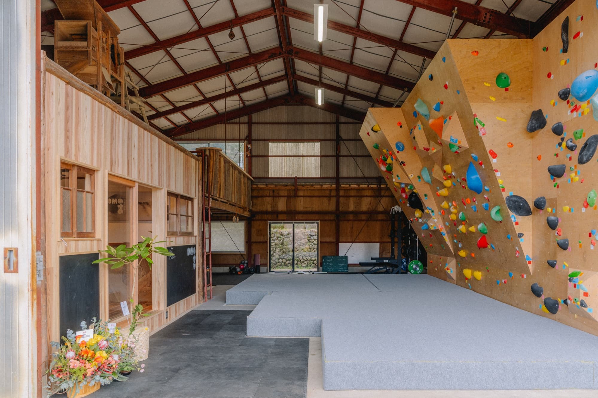 Nomanoma warehouse interior with bouldering wall